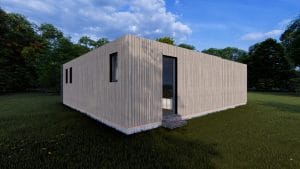 Module en bois contemporain gris avec bardage vertical, posé sur une pelouse verte entourée d'arbres sous un ciel bleu lumineux.