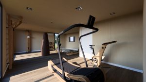 Salle de sport moderne en bois avec des équipements design et épurés, baignée par une lumière naturelle grâce à de grandes ouvertures.
